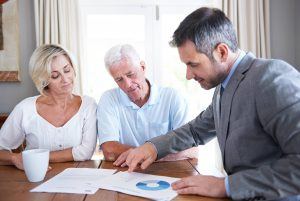 Couple discussing tax efficient investing with a financial adviser